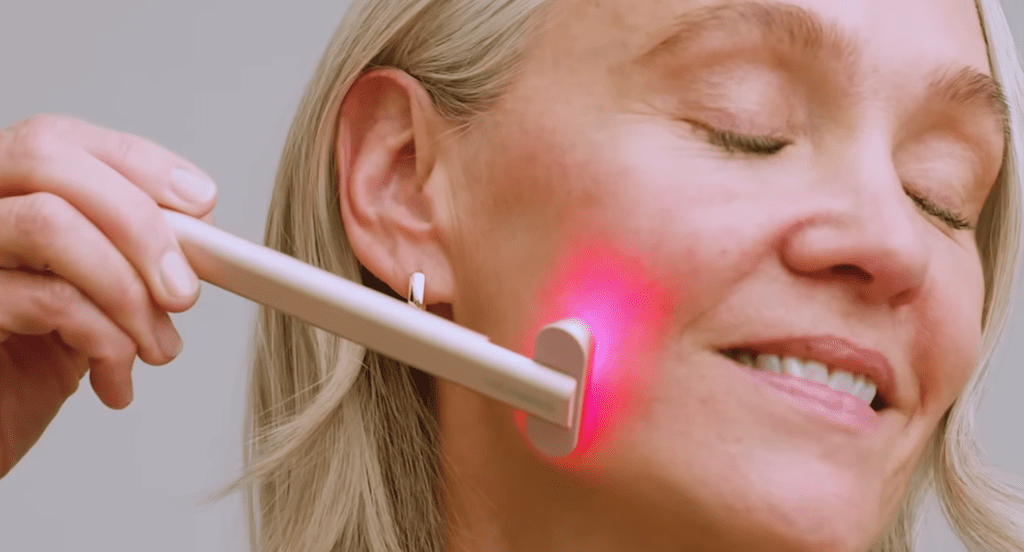 woman using the solawave radiant renewal skincare wand on her jawline to get rid of smile lines and fine lines