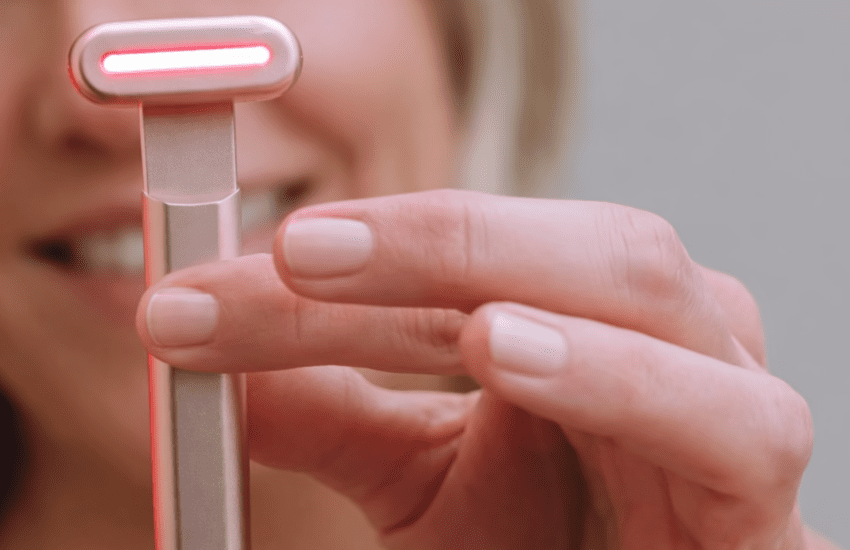 Close-up of Solawave wand red light LEDs activated during facial treatment