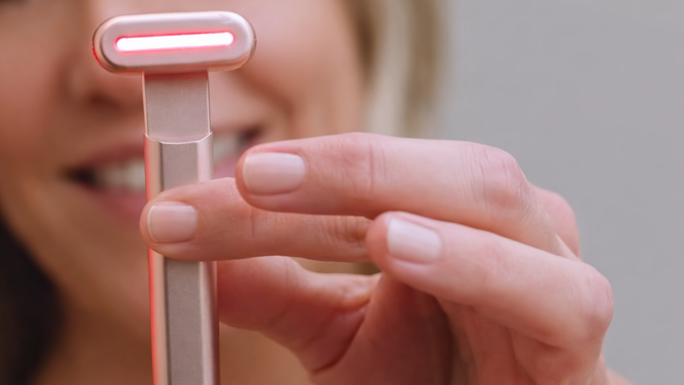 Close-up of Solawave wand red light LEDs activated during facial treatment