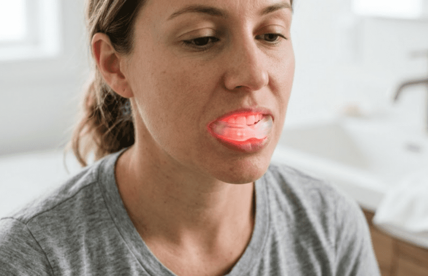 woman using red light therapy for gum recession