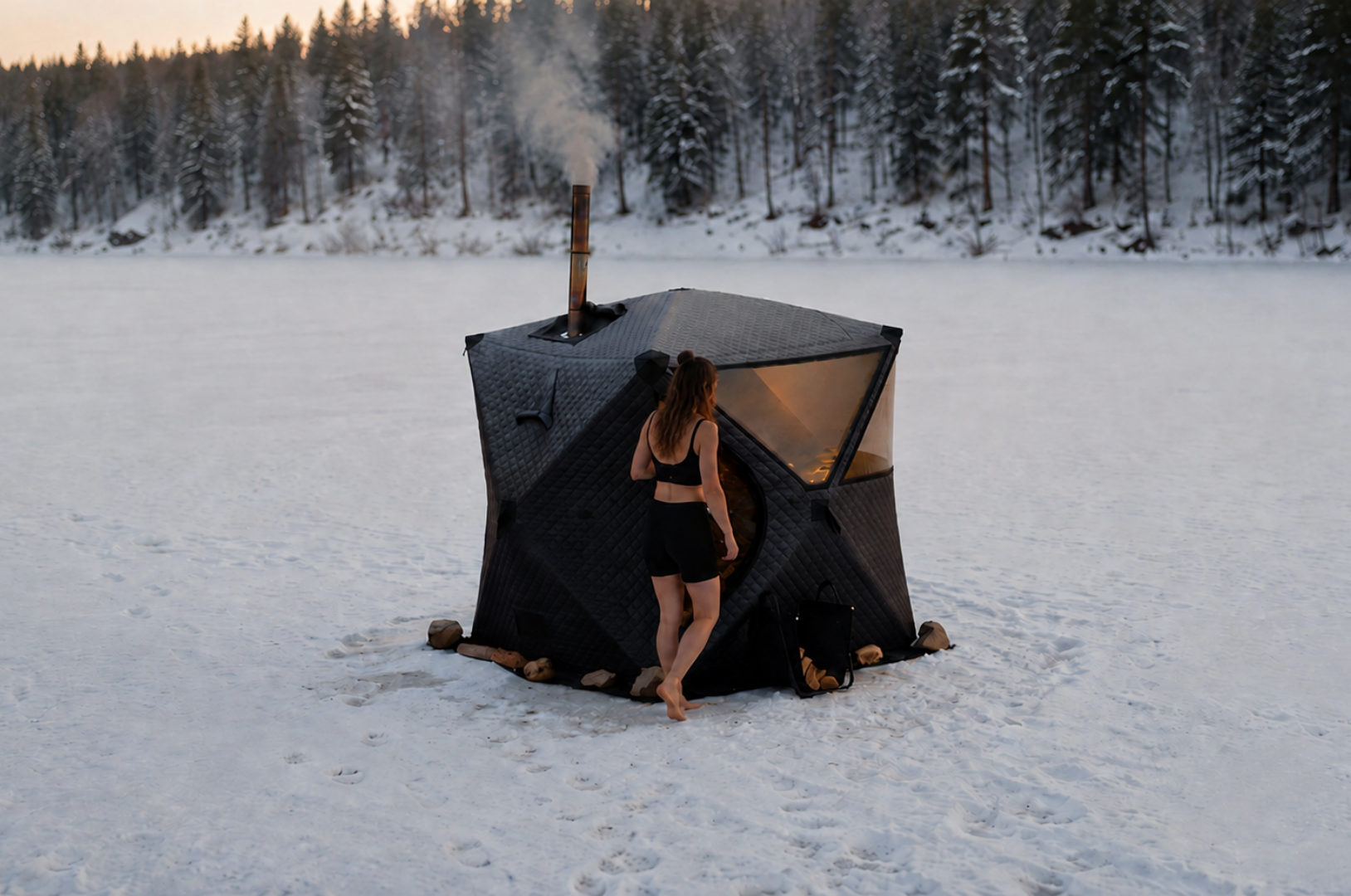Sweat Tent portable wood-fired sauna in a snowy mountain landscape
