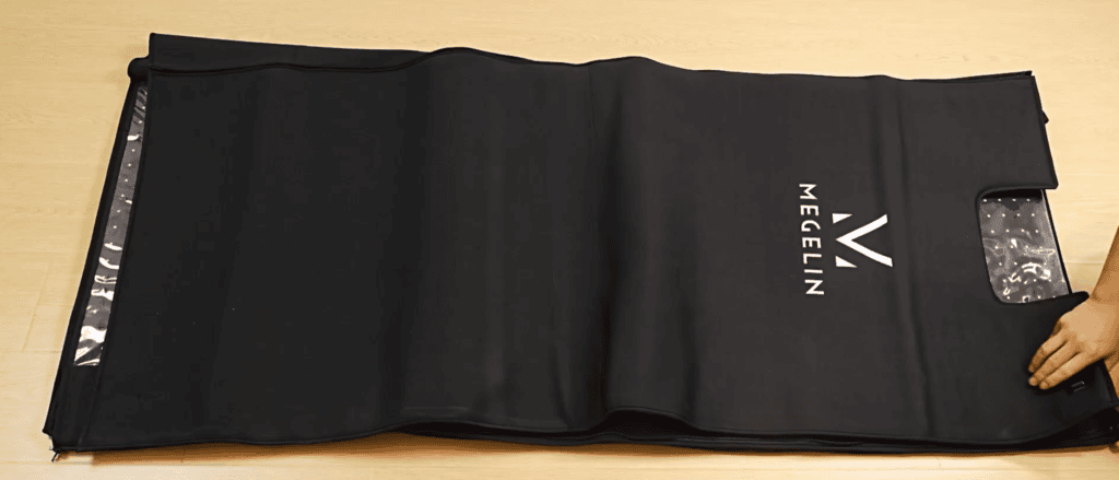 Close-up of the MEGELIN red light therapy bag's black outer material and reflective interior lining